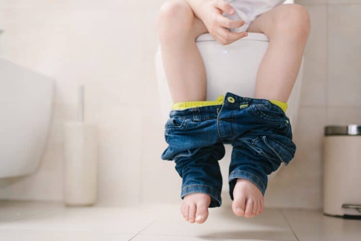 boy sitting on the toilet