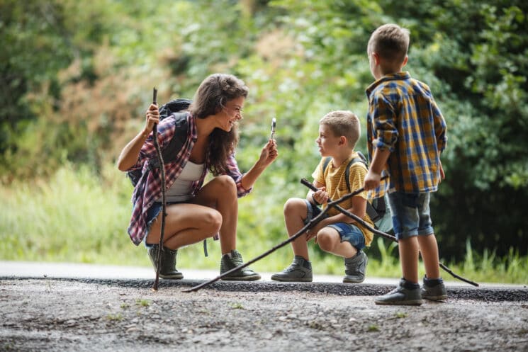 mom with kids hiking in the woods