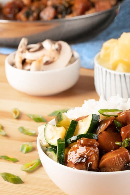 chicken teriyaki with mushrooms and pineapple in bowls