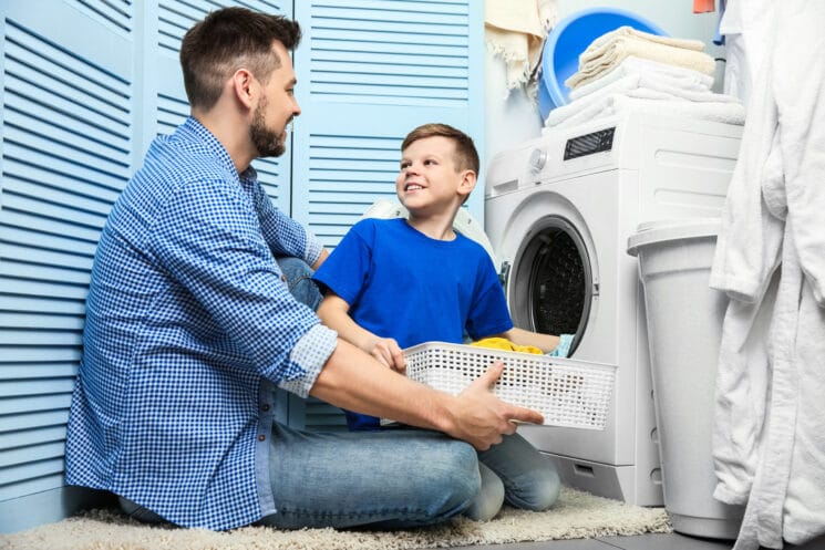 boy and his dad doing the laundry