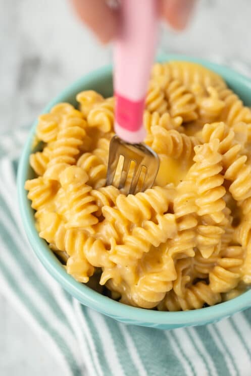 creamy yellow mac and cheese in a bowl made from rotini shape pasta