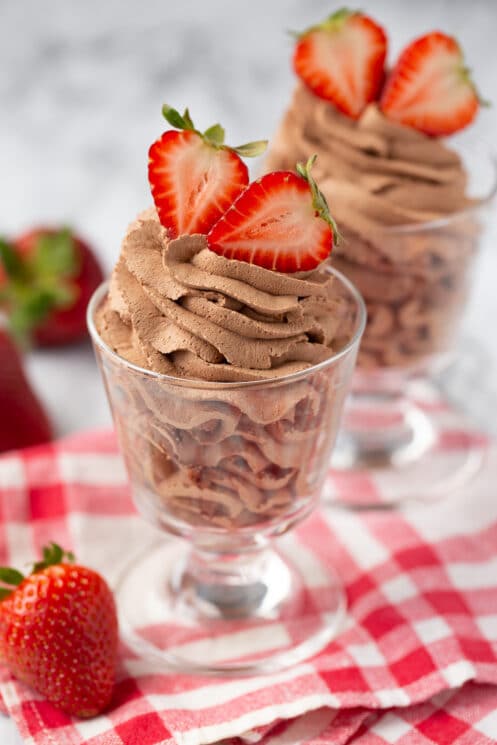 chocolate mousse in glasses with strawberries on top