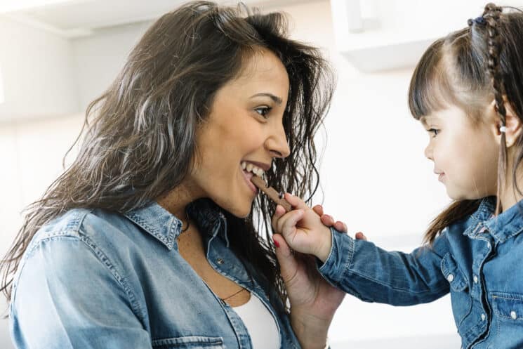 mom and daughter sharing a piece of chocolate