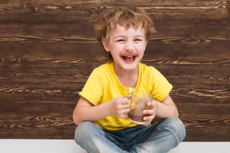 happy boy drinking chocolate milk