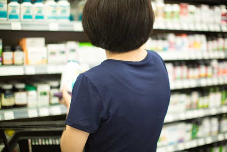 mom choosing probiotics at the store