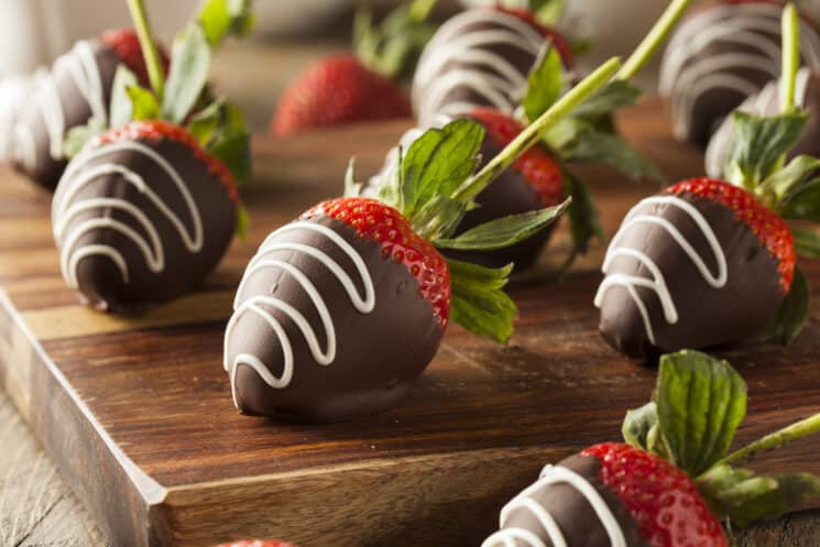 chocolate covered strawberries on a cutting board