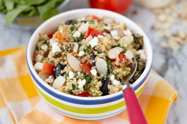 freshly made quinoa with mixed vegetables in a striped bowl