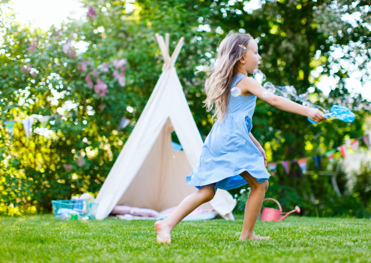 girl playing outdoor activities on the grass