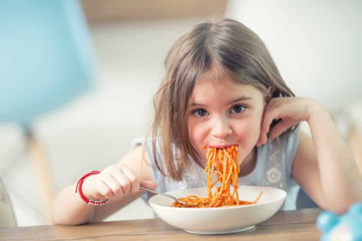 girl eating spaghetti as part of a healthy diet for kids