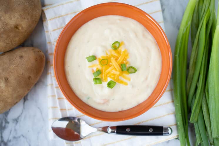 fresh homemade bowl of potato soup with a spoon