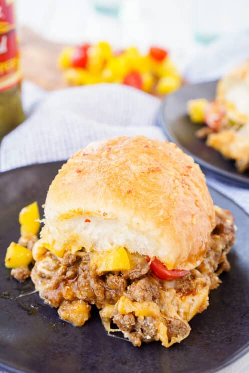 slider bun filled with ground beef, melty cheese and bell peppers