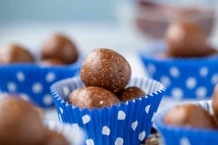 fudgy energy balls inside paper muffin liners with blue polka dots