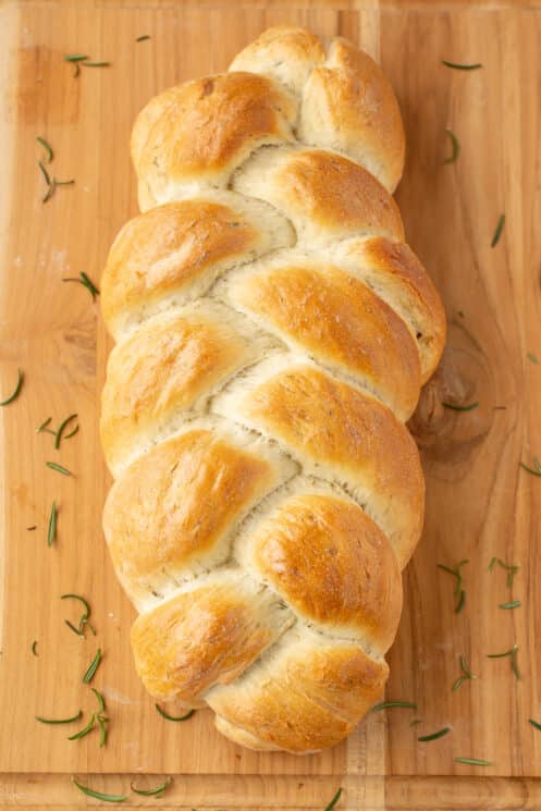 finished loaf of braided bread on a cutting board