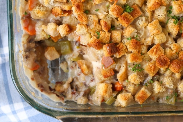 chicken and wild rice casserole in serving dish with first serving taken out