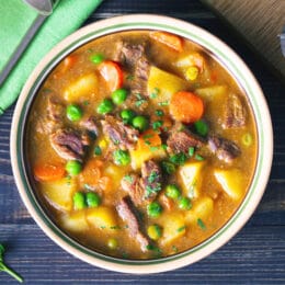 Instant Pot Vegetable Beef Soup with carrots, potatoes, beef, peas and in savory broth