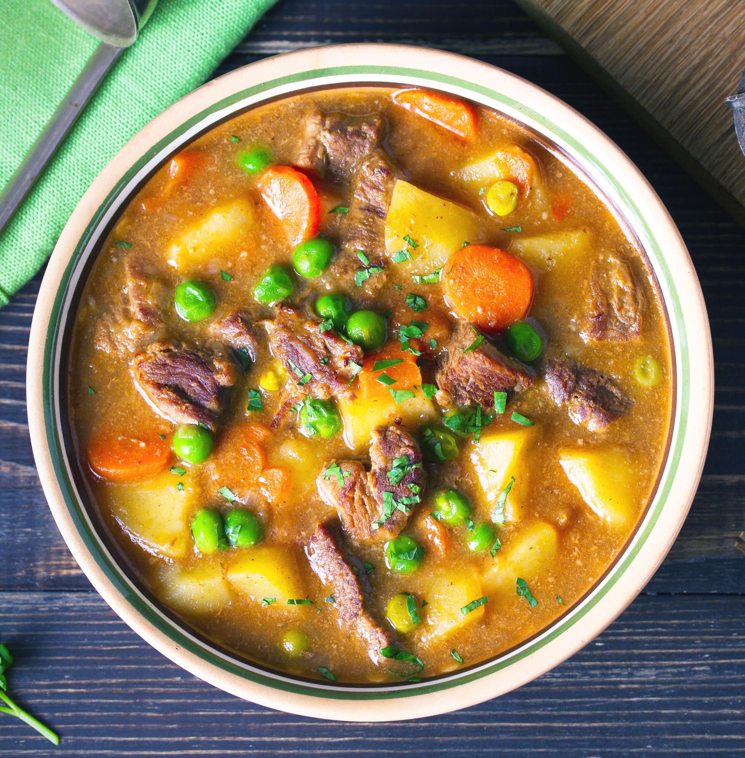 Instant Pot Vegetable Beef Soup with carrots, potatoes, beef, peas and in savory broth