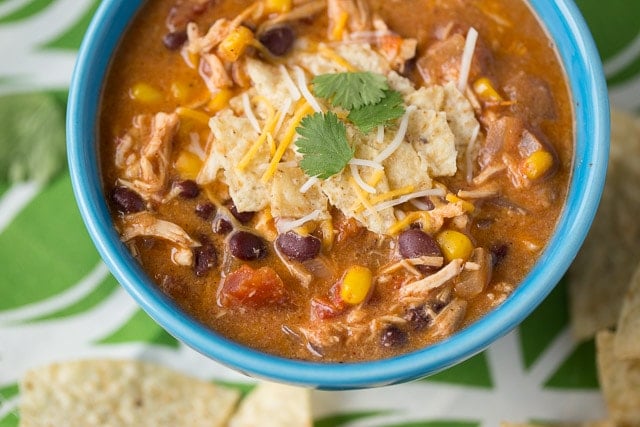 bowl of delicious chili with cilantro and chips