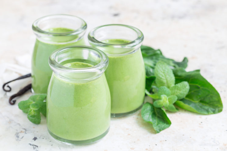 3 glass jars of healthy green smoothie as a makeover of a shamrock shake made with mint, spinach and vanilla