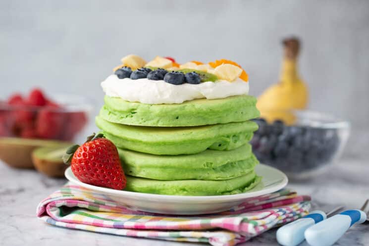 Toddler-Friendly Breakfast Meal Plan 4 green pancakes topped with whipped cream and diced fruit pieces