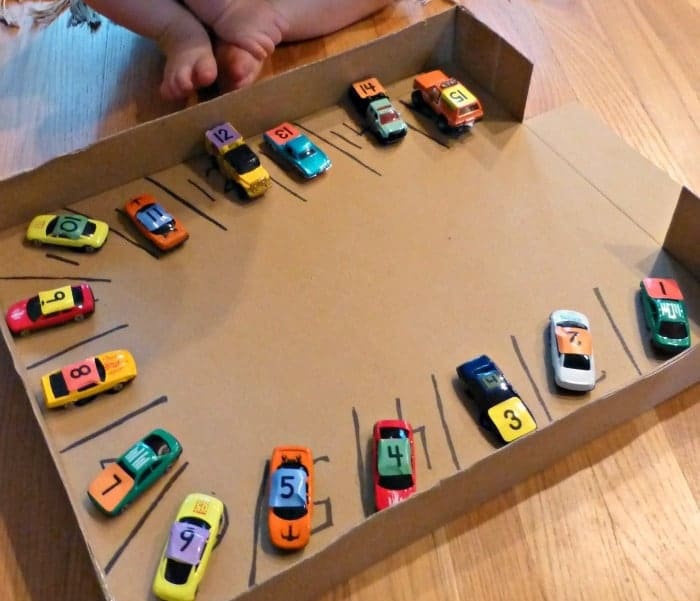 recycled cardboard box with diy matchbox car parking lot