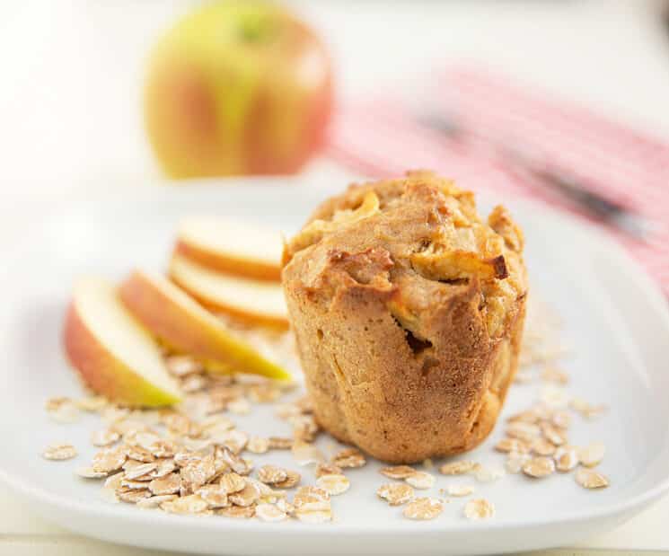 Apple Oat Muffin with apple slices in the background.
