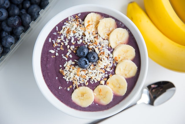 Blueberry smoothie bowl with bananas and toasted coconut on top