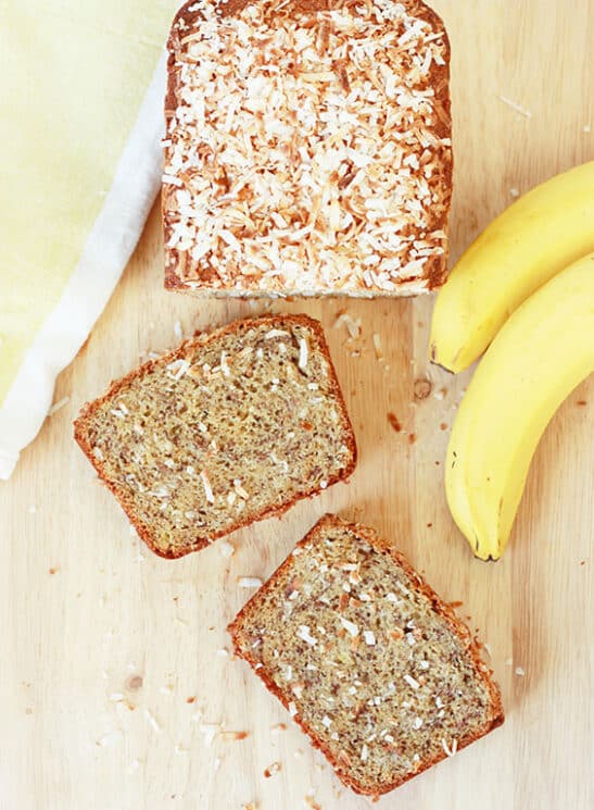 Overhead view of coconut banana bread with two slices