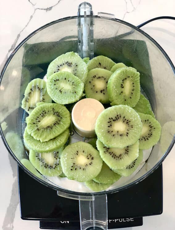 Frozen kiwi fruit in a food processor