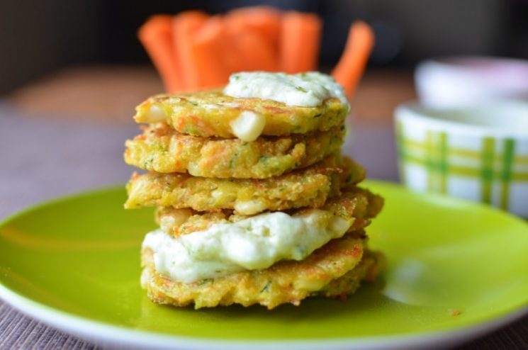 stack of zucchini pancakes with sauce