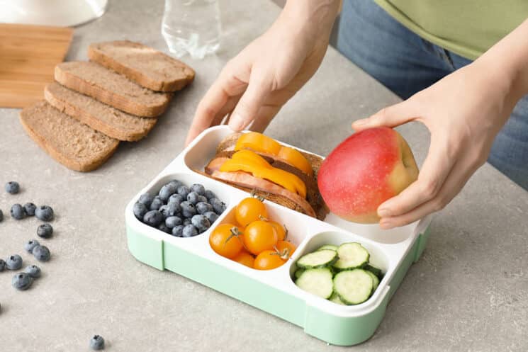 packing food into a bento style lunch box