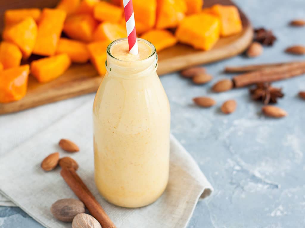 pumpkin shake with pumpkin chunks in the background