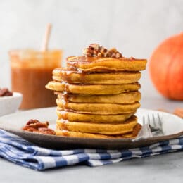 stack of whole grain pumpkin pancakes with caramel syrup