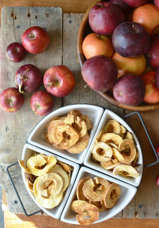 Dried Apples in a white dish with red apples in a bowl