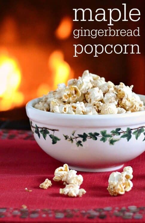 Popcorn in a holiday bowl in front of a fireplace