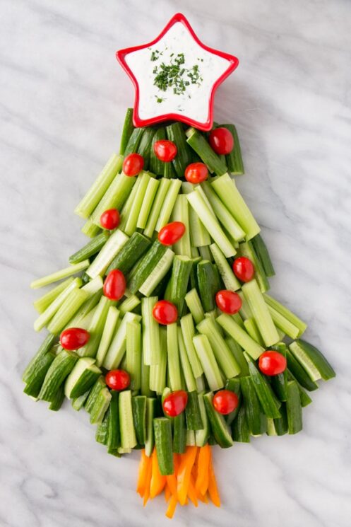 cucumber and celery christmas tree topped with a small star container filled with dip