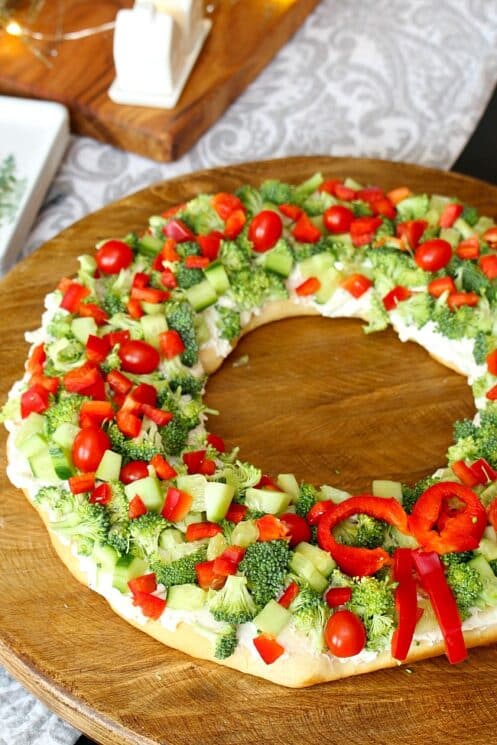 Pizza shaped in a wreath topped with broccoli, peppers and cucumbers