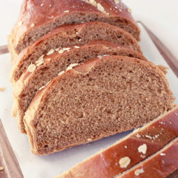 sweet brown bread sliced on a cutting board