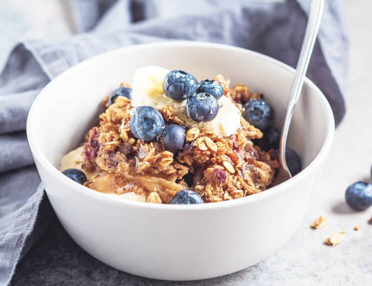 Baked blueberry oatmeal in a white bowl with a spoon