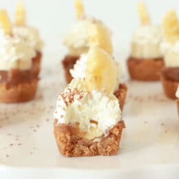 Banoffee Pie Bites with a bite removed showing the whip cream and the banana slice