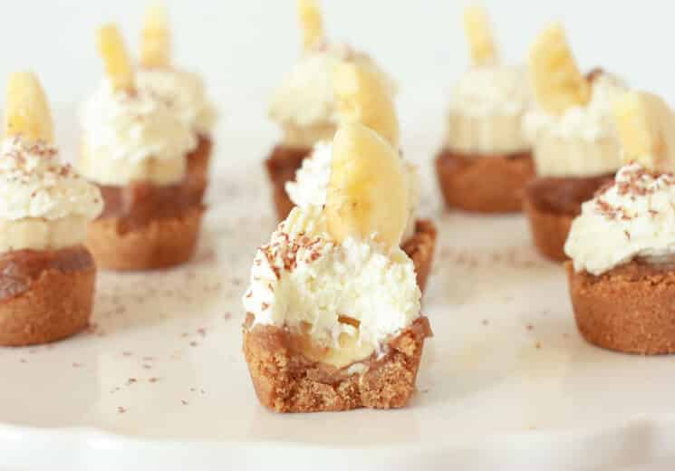 banoffee pie bites with a bite taken out showing the whip cream and banana slice