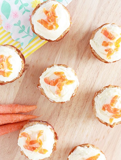 Carrot Cake Muffins - Super Healthy Kids 1 overhead view of carrot cake muffins on a wood surface with carrot curls