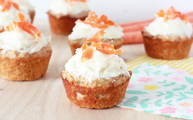 carrot cake muffin closeup with greek yogurt frosting and carrot curls