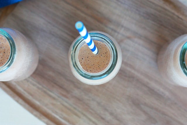 Homemade Chocolate Milk (No Added Sugars) 1 overhead view of chocolate milk in a milk bottle with a blue and white striped straw