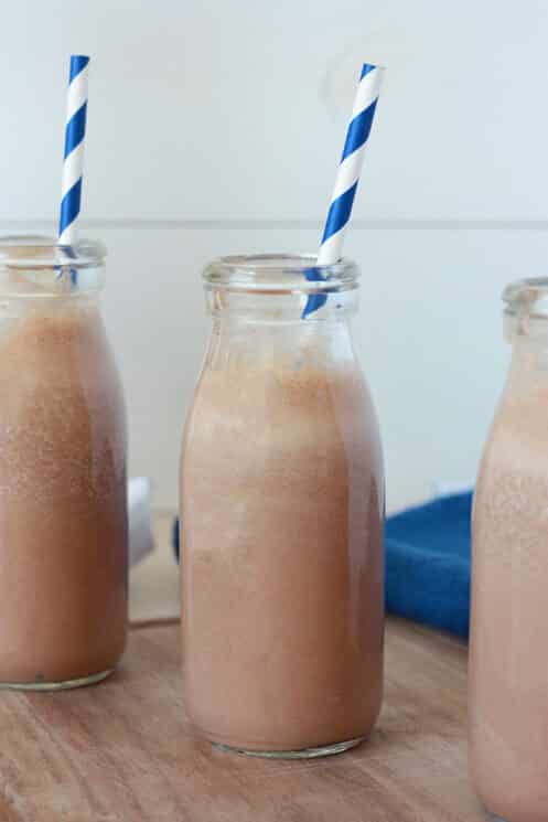 Homemade Chocolate Milk (No Added Sugars) 4 close up view of a milk bottle with chocolate milk and blue and white striped straw
