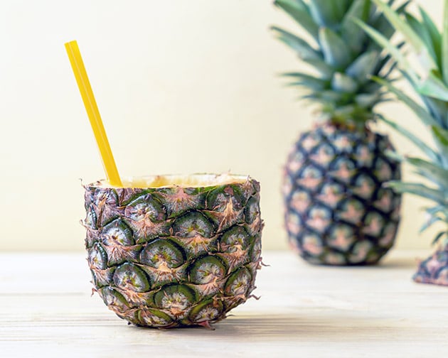 pineapple cooler inside of a pineapple with a straw