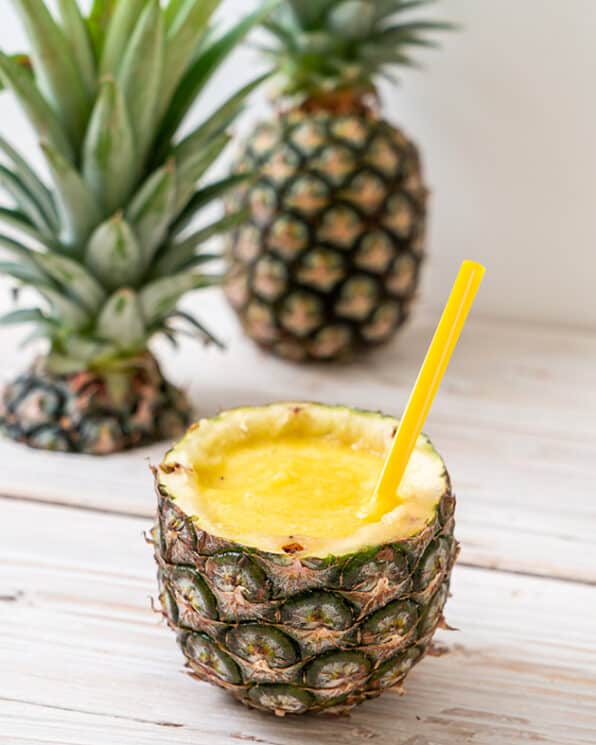 pineapple cooler inside of a pineapple with a straw