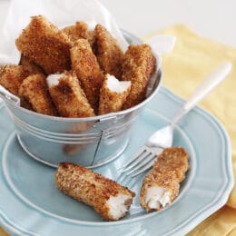fish sticks on a blue plate with fork