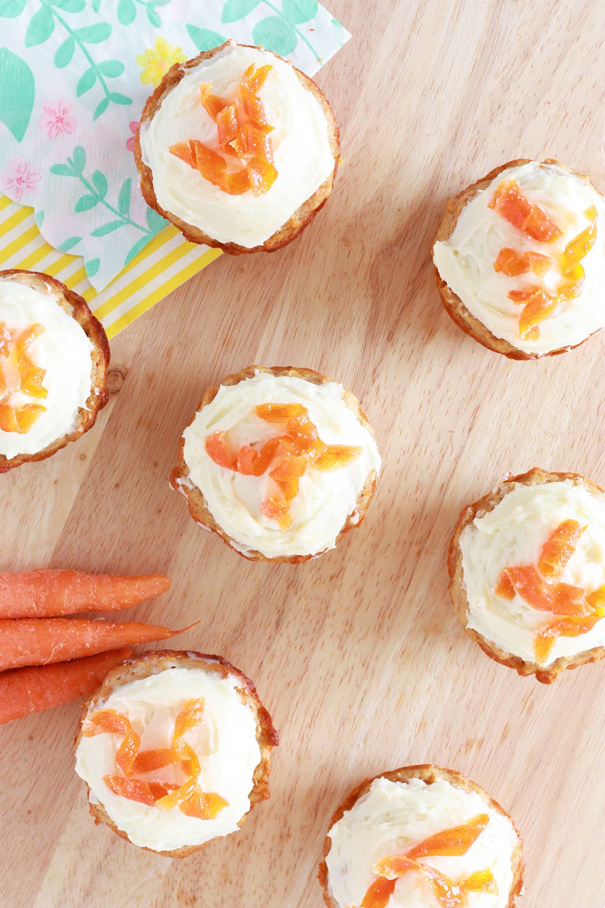 carrot cake muffins with sugared carrots on top