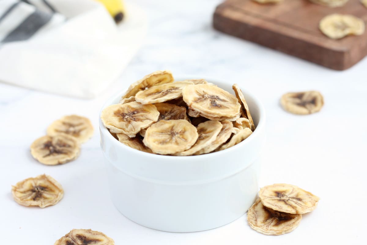 homemade banana chips in a small ceramic bowl