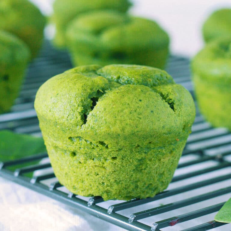 closeup view of sweet spinach muffins on a cooling rack